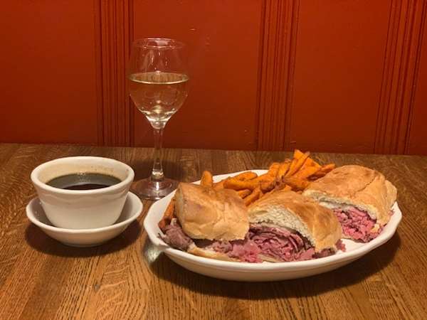 An order of French Dip Au Ju and white wine. 